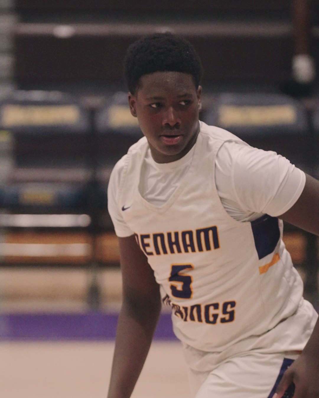 A basketball player mid-game, filmed by Mike Lenzs